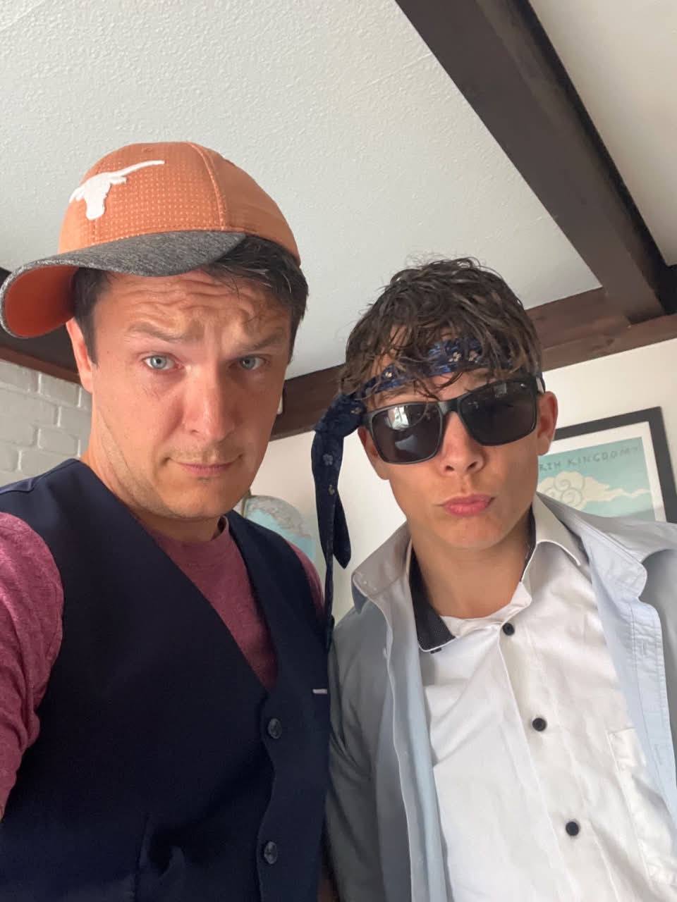 A father and his son in sunglasses and dressing-up clothes, mid fashion runway